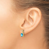 14k Yellow Gold Stud Earrings with Oval Blue Topaz and Diamond Accents, Crossover Design