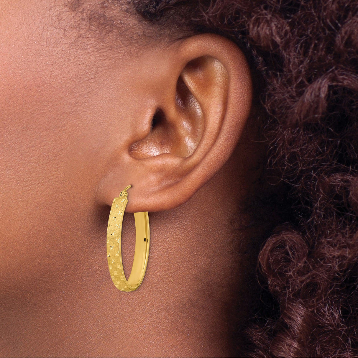 14k Yellow Gold Oval Hoop Earrings with Diamond Cut Star Pattern and Textured Finish